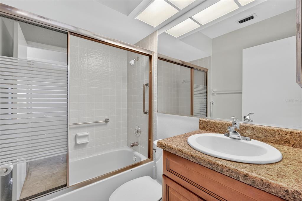 321 Windrush Loop Tarpon Springs, FL 34689 - Photo 29 of 47 a bathroom with a granite countertop sink toilet and shower