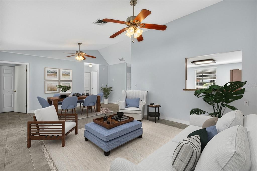 321 Windrush Loop Tarpon Springs, FL 34689 - Photo 3 of 47 a living room with furniture a chandelier