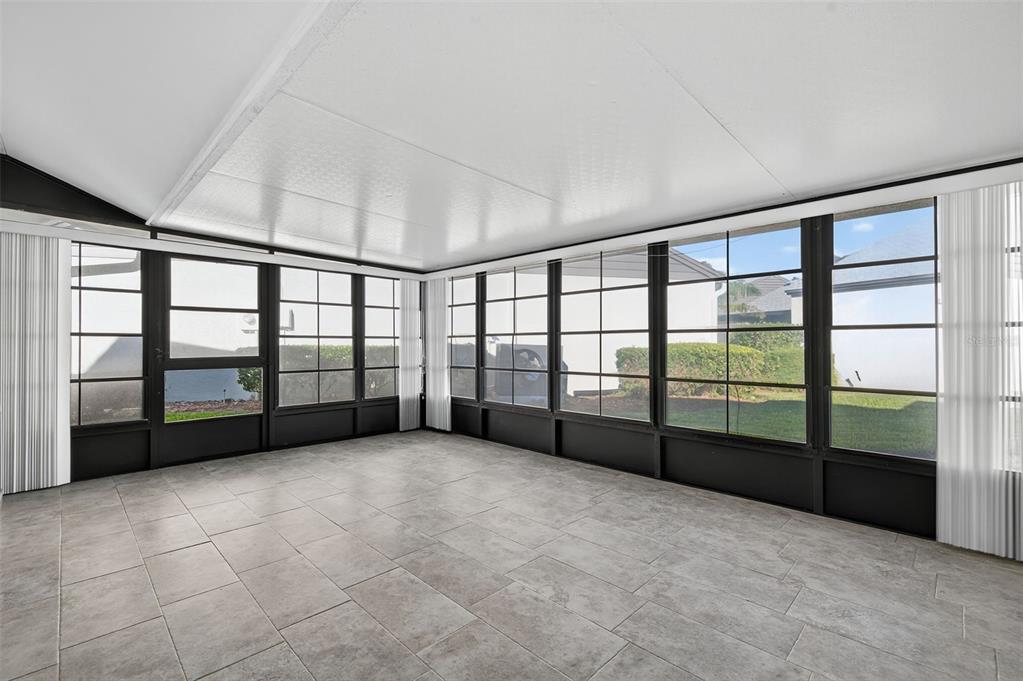 321 Windrush Loop Tarpon Springs, FL 34689 - Photo 31 of 47 a view of an empty room with windows and a balcony
