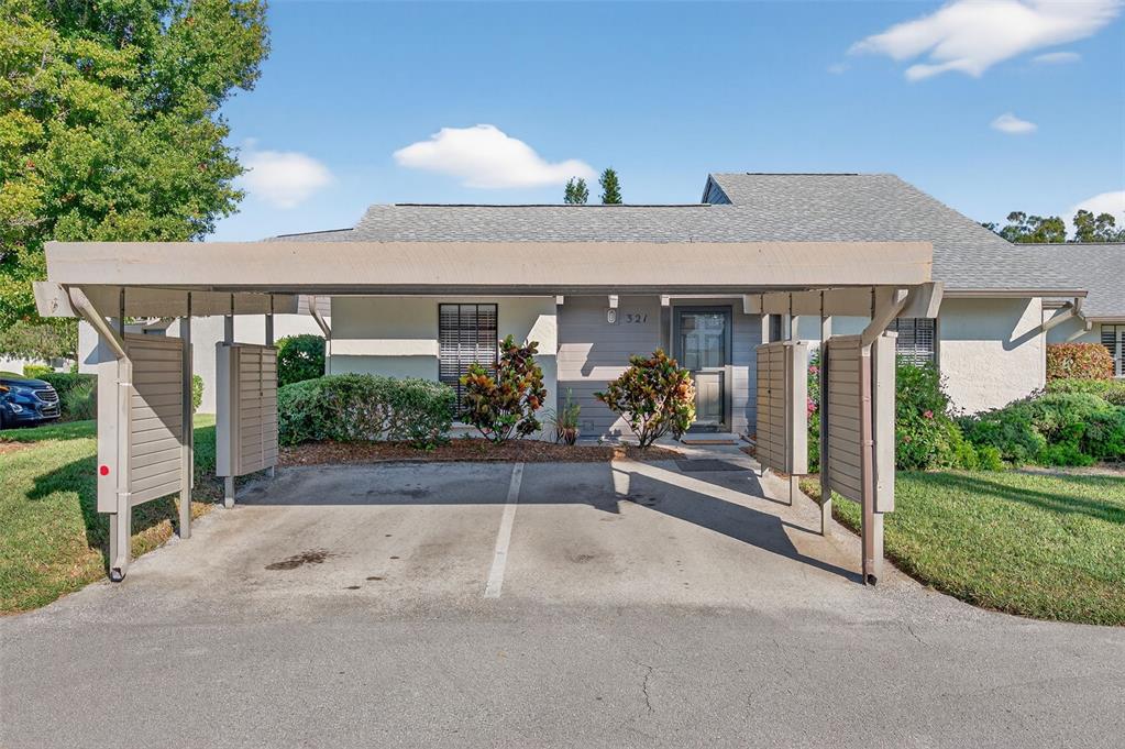 321 Windrush Loop Tarpon Springs, FL 34689 - Photo 6 of 47 a view of a house with porch and garden