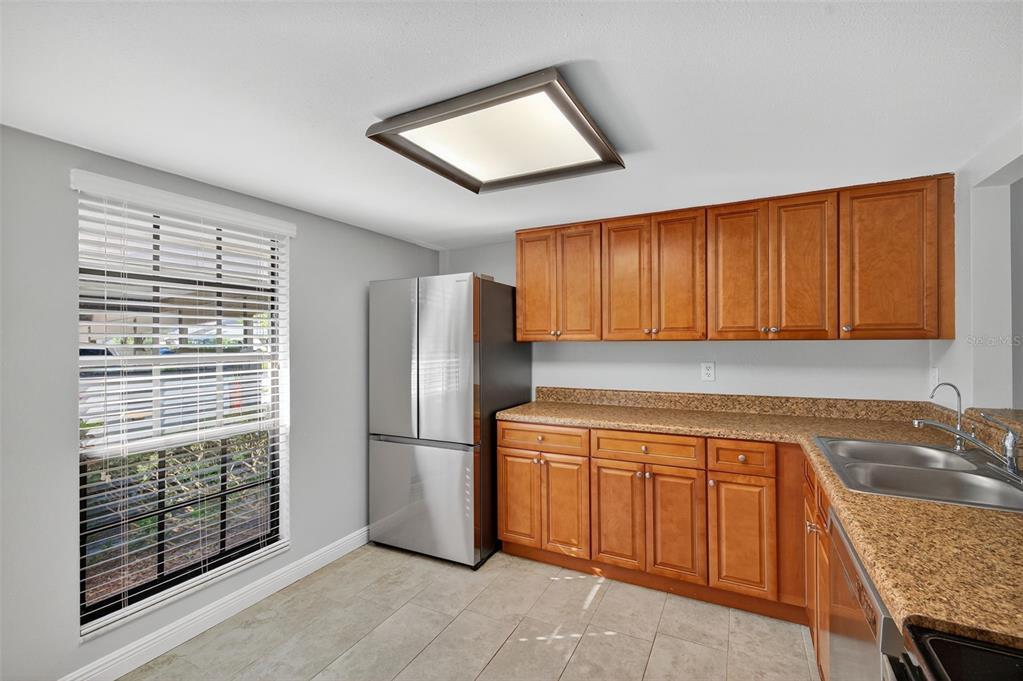 321 Windrush Loop Tarpon Springs, FL 34689 - Photo 10 of 47 a kitchen with a refrigerator a sink and cabinets