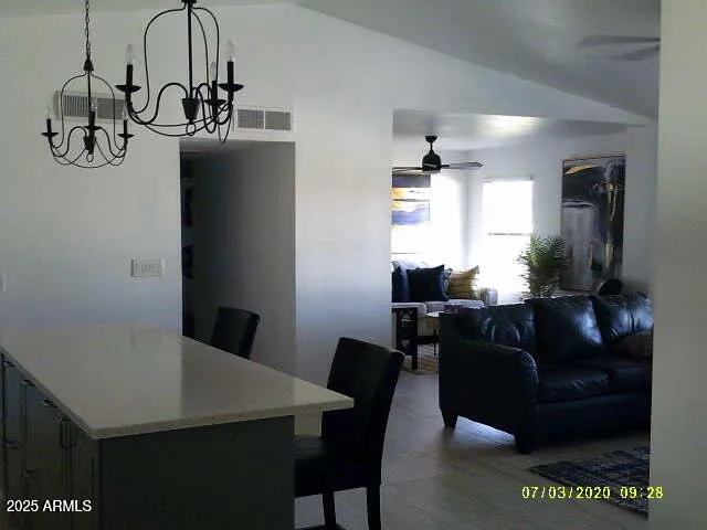 a living room with furniture a window and wooden floor