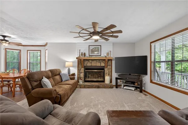 a living room with furniture a window and a fireplace