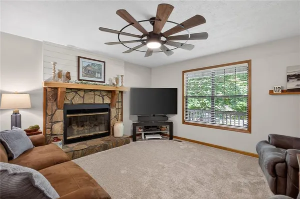a living room with furniture tv and window