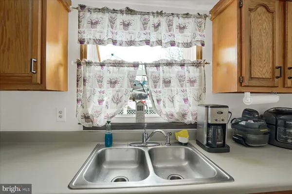 a kitchen with a sink and a window