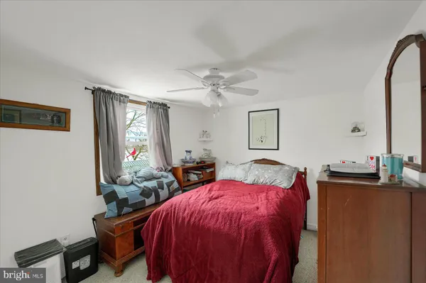 a bed room with a bed mirror and a window