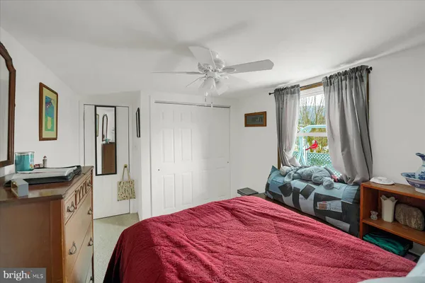 a bedroom with a bed and a flat tv screen