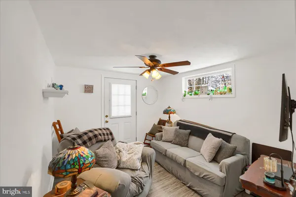 a living room with furniture and a chandelier