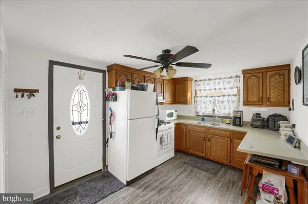 a kitchen with a sink appliances and cabinets