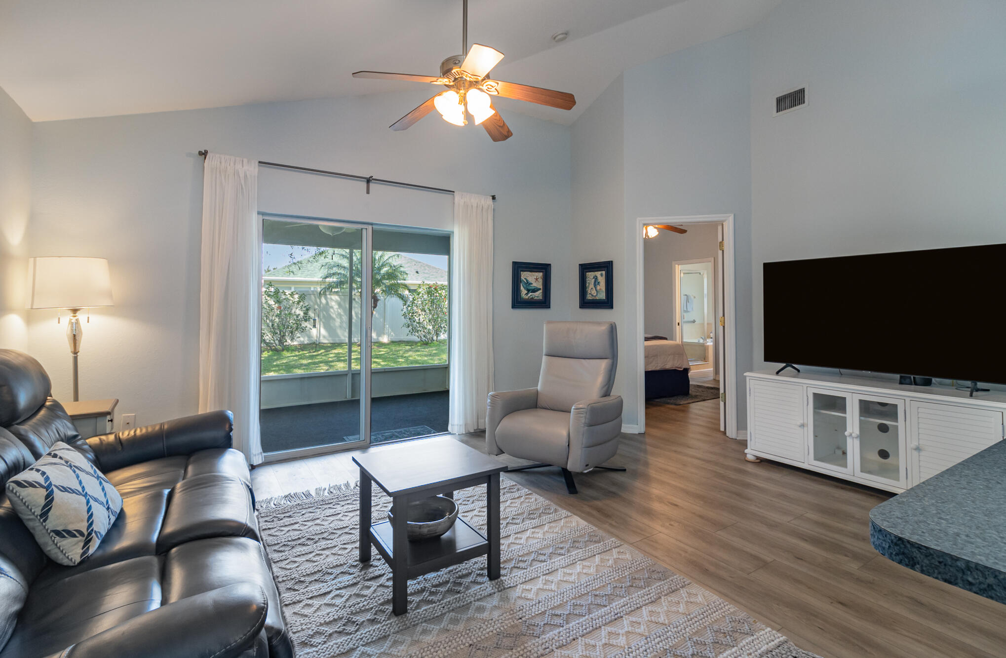 3726 Town Square Boulevard, Unit 84 Melbourne, FL 32901 - Photo 11 of 21 a living room with furniture a flat screen tv and a large window