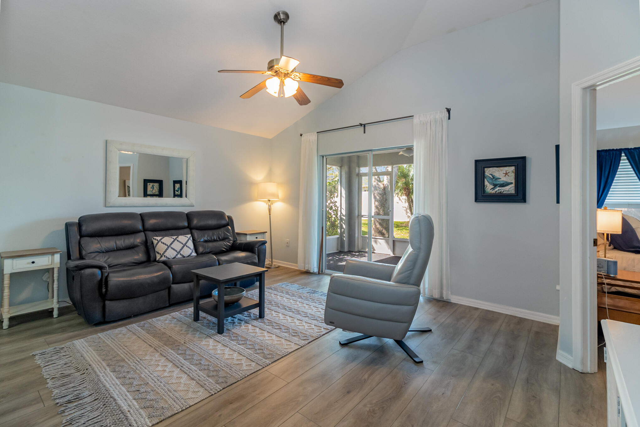 3726 Town Square Boulevard, Unit 84 Melbourne, FL 32901 - Photo 17 of 21 a living room with furniture and a chandelier