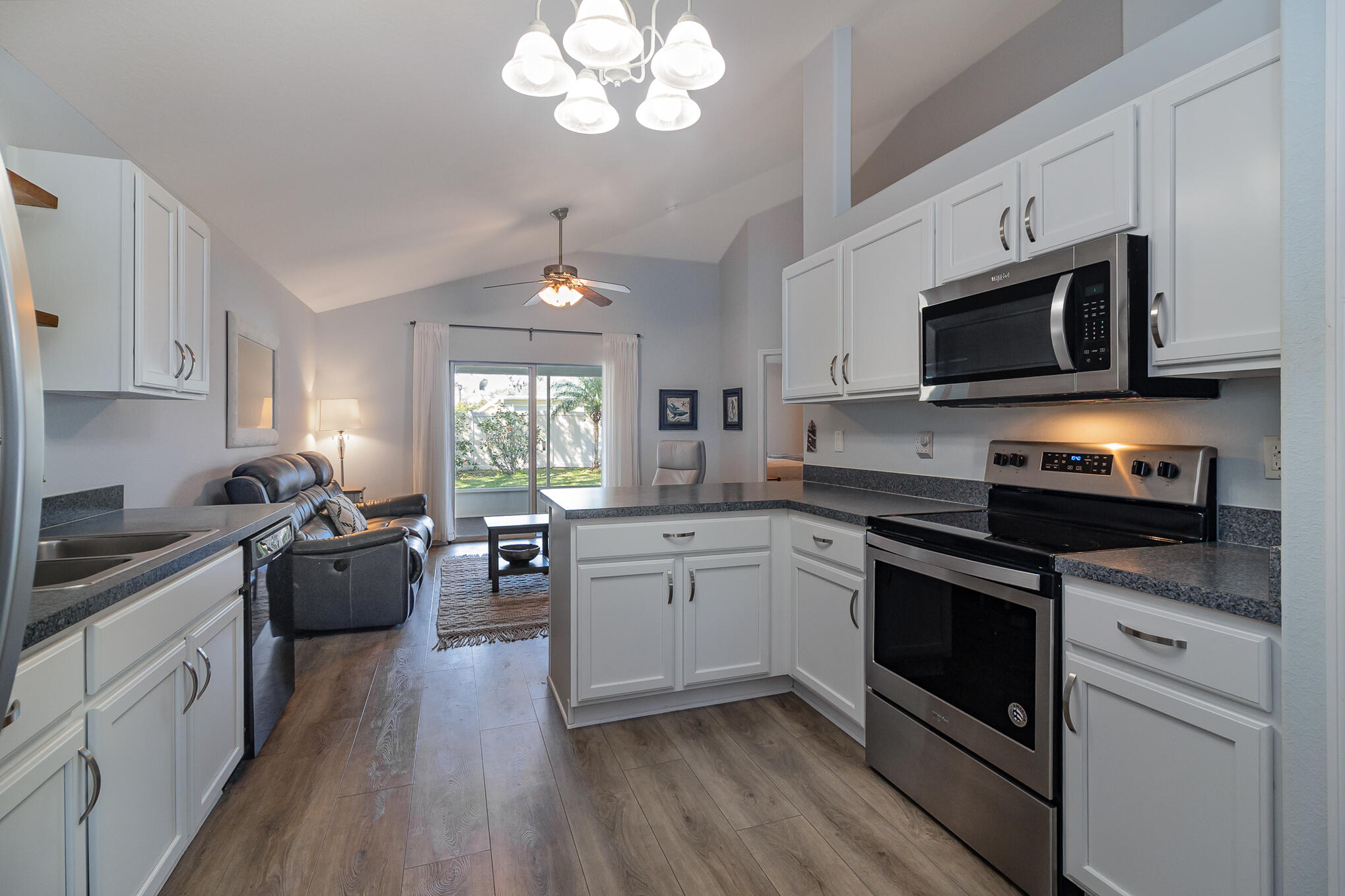3726 Town Square Boulevard, Unit 84 Melbourne, FL 32901 - Photo 18 of 21 a kitchen with stainless steel appliances granite countertop wooden floors and granite counter tops