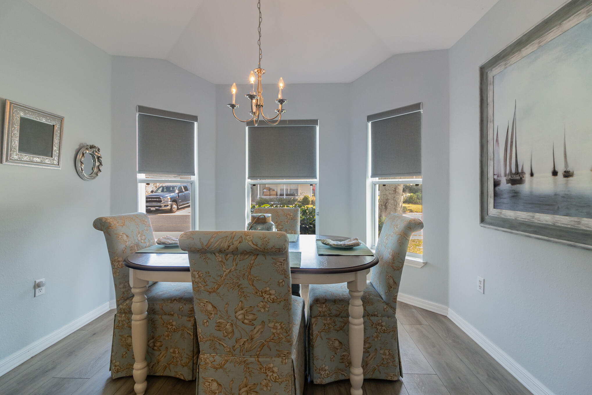 3726 Town Square Boulevard, Unit 84 Melbourne, FL 32901 - Photo 19 of 21 a dining room with furniture a chandelier and wooden floor
