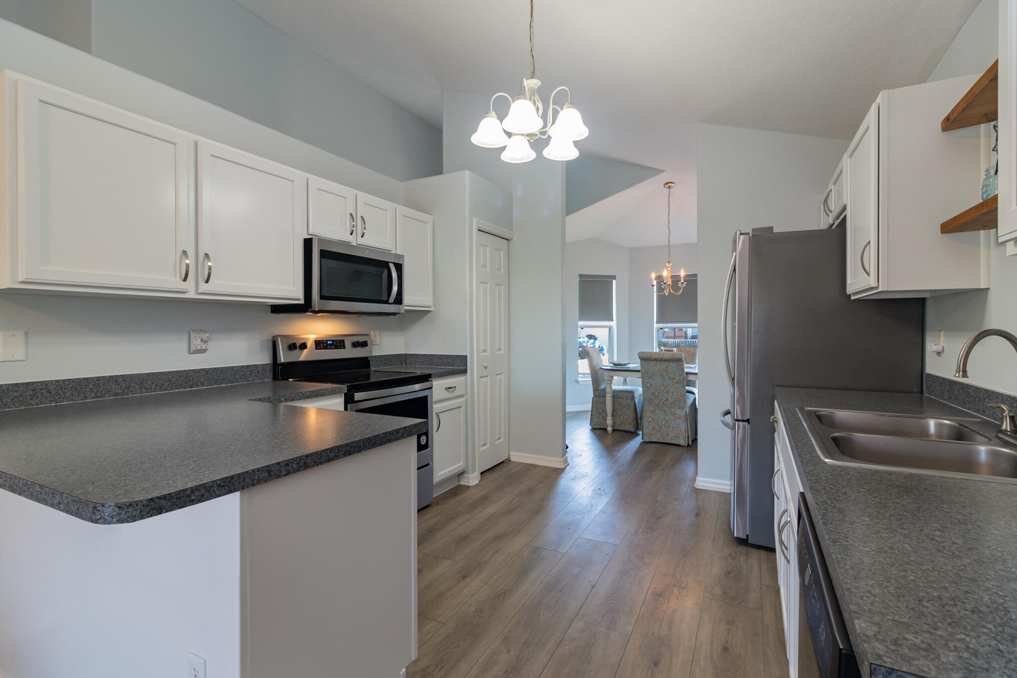 3726 Town Square Boulevard, Unit 84 Melbourne, FL 32901 - Photo 9 of 21 a kitchen with stainless steel appliances granite countertop a sink stove and refrigerator