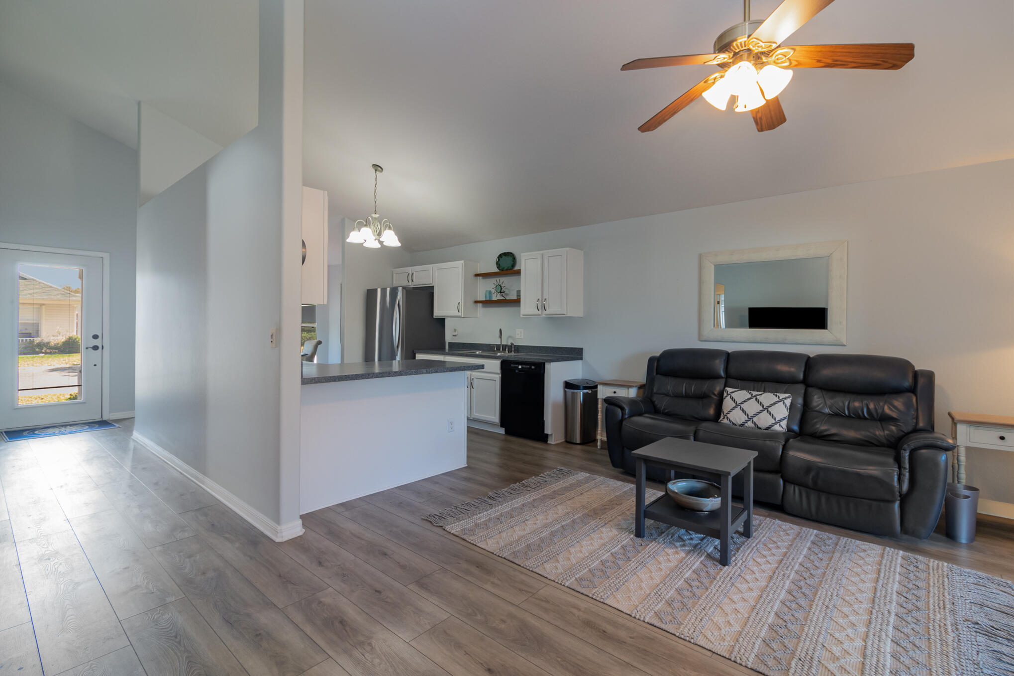 3726 Town Square Boulevard, Unit 84 Melbourne, FL 32901 - Photo 10 of 21 a living room with furniture and a wooden floor