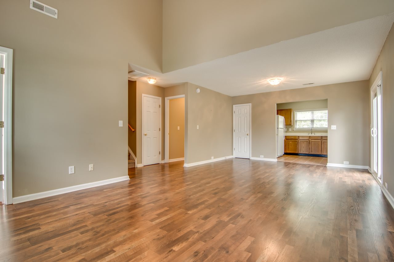 5008 Gable Ridge Drive Durham, NC 27713 - Photo 3 of 20 a view of an empty room with window and wooden floor