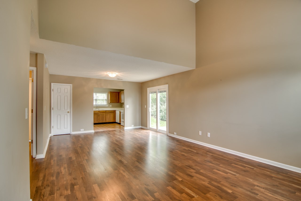 5008 Gable Ridge Drive Durham, NC 27713 - Photo 4 of 20 a view of an empty room with wooden floor and a window