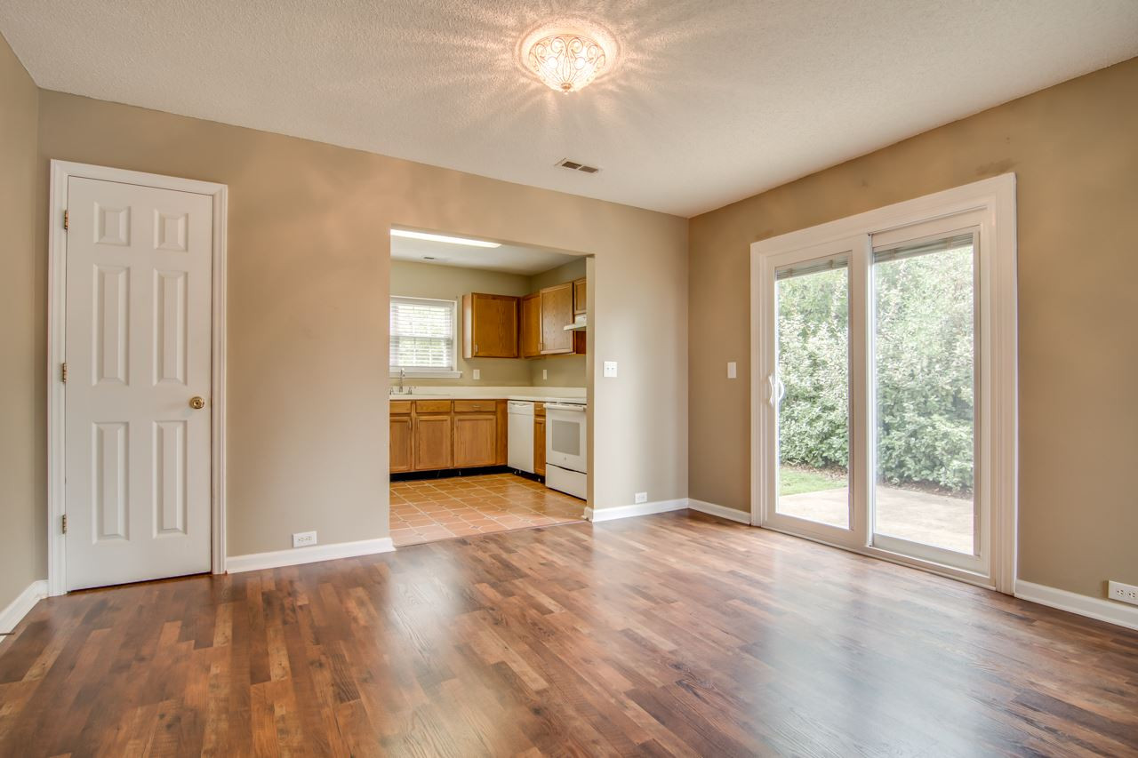 5008 Gable Ridge Drive Durham, NC 27713 - Photo 5 of 20 a view of a big room with wooden floor and a kitchen