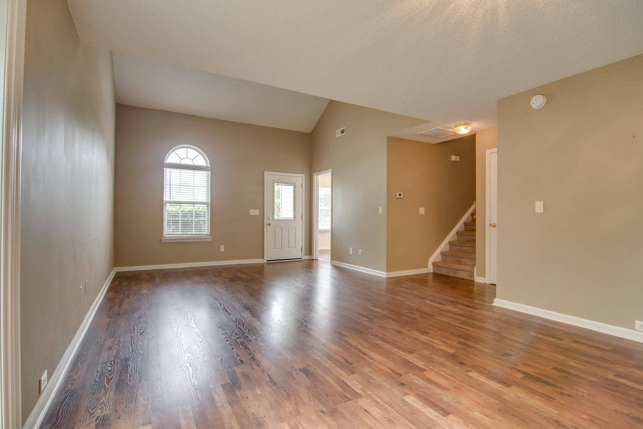 5008 Gable Ridge Drive Durham, NC 27713 - Photo 7 of 20 a view of an empty room with wooden floor and a window