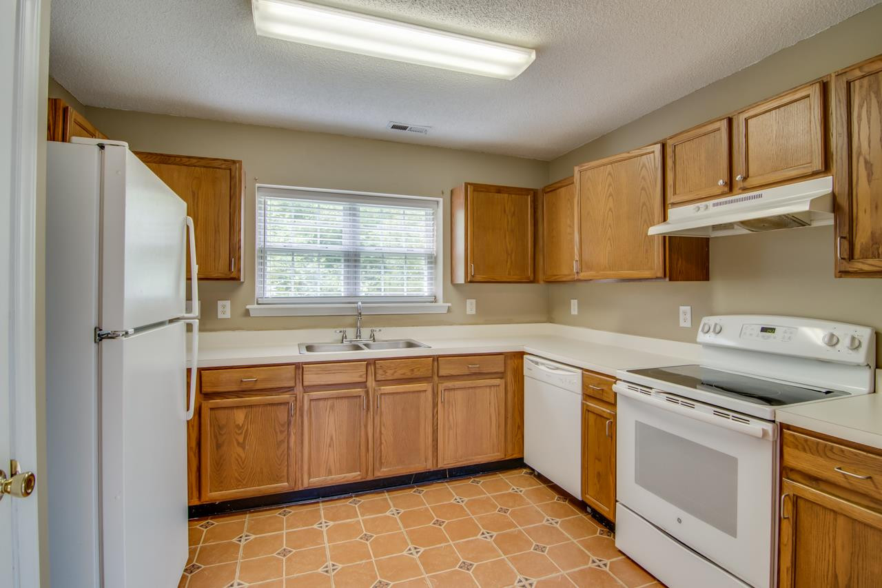 5008 Gable Ridge Drive Durham, NC 27713 - Photo 8 of 20 a kitchen with a sink stove and cabinets