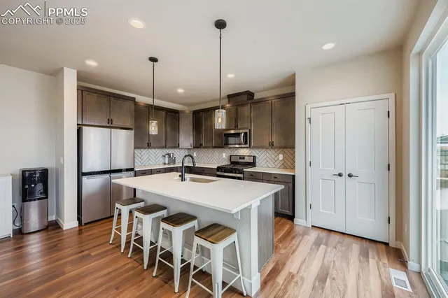 a kitchen with a sink stove and cabinets