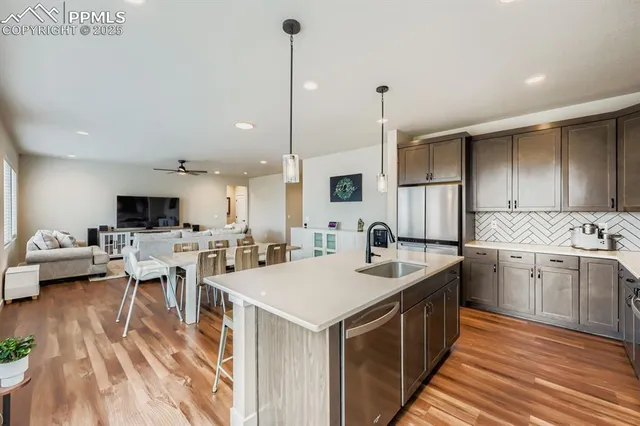 a kitchen with sink stove and living room view