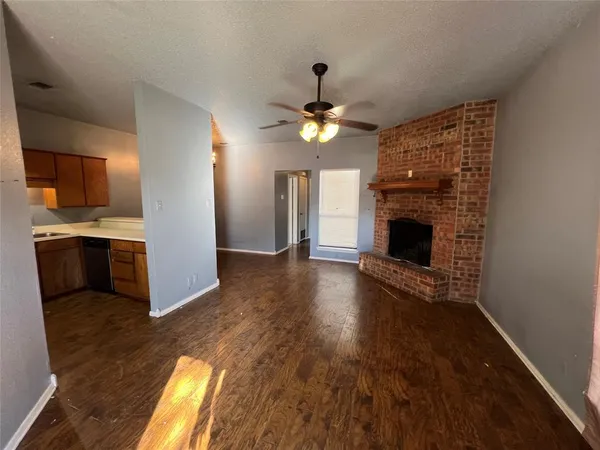 a view of open kitchen stove microwave and cabinets