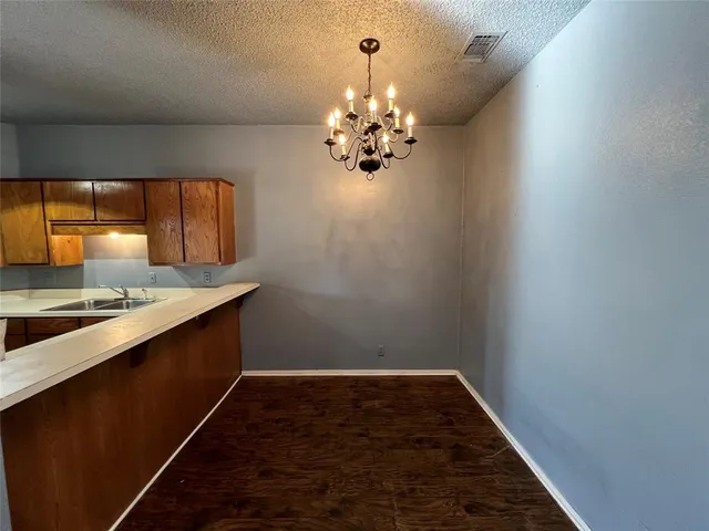 a kitchen with a sink and chandelier