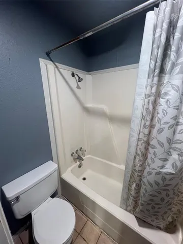 a bathroom with a toilet and a bathtub