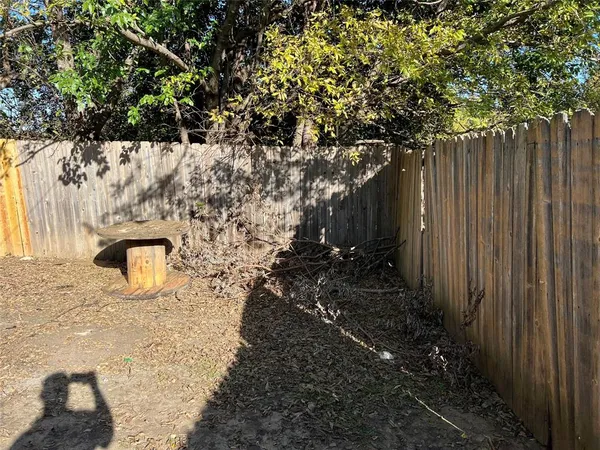 a bunch of trees with wooden fence