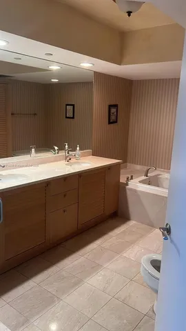 a bathroom with a sink mirror vanity and toilet