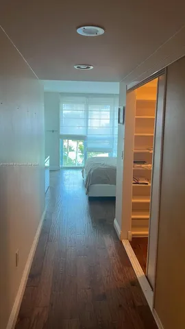 a view of hallway with stairs and wooden floor