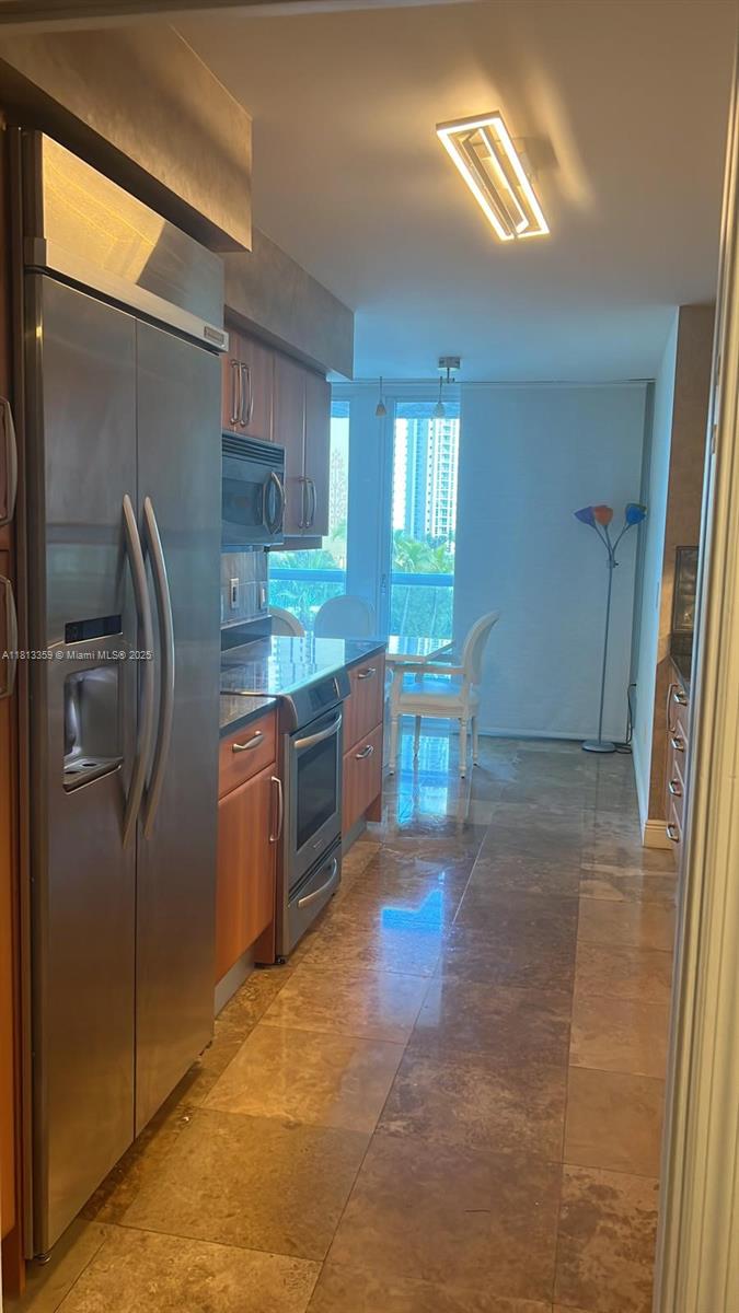 16500 Collins Avenue, Unit 652 Sunny Isles Beach, FL 33160 - Photo 6 of 6 a kitchen with stainless steel appliances granite countertop a refrigerator and a sink
