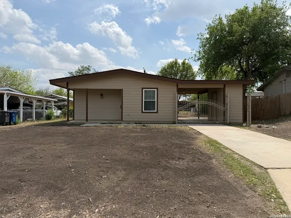 a view of a house with a yard and garage
