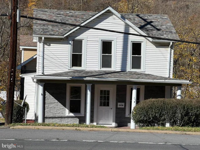 a view of a white house with large windows