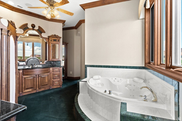 5615 East Eight Mile Gap Road Kanab, UT 84741 - Photo 20 of 81 Full bathroom with vanity, a jetted tub, crown molding, ceiling fan, and dark carpet