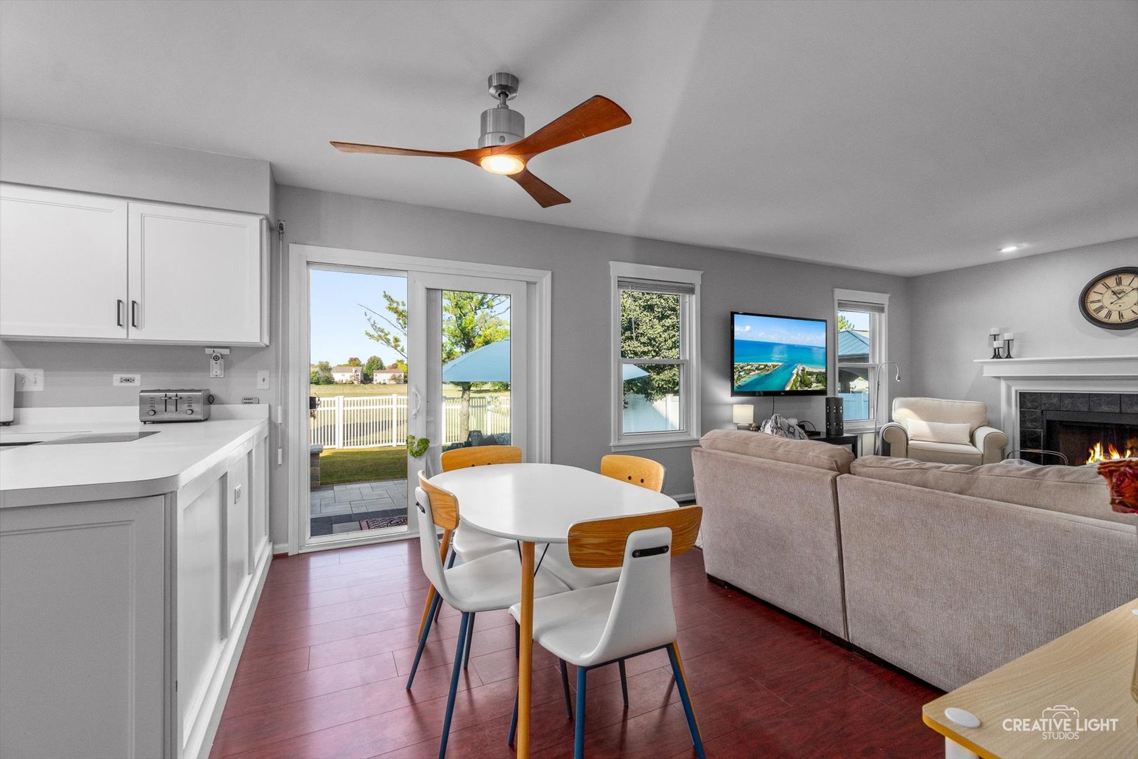 895 Lowell Lane Naperville, IL 60540 - Photo 11 of 40 a living room with furniture a fireplace and a open kitchen view