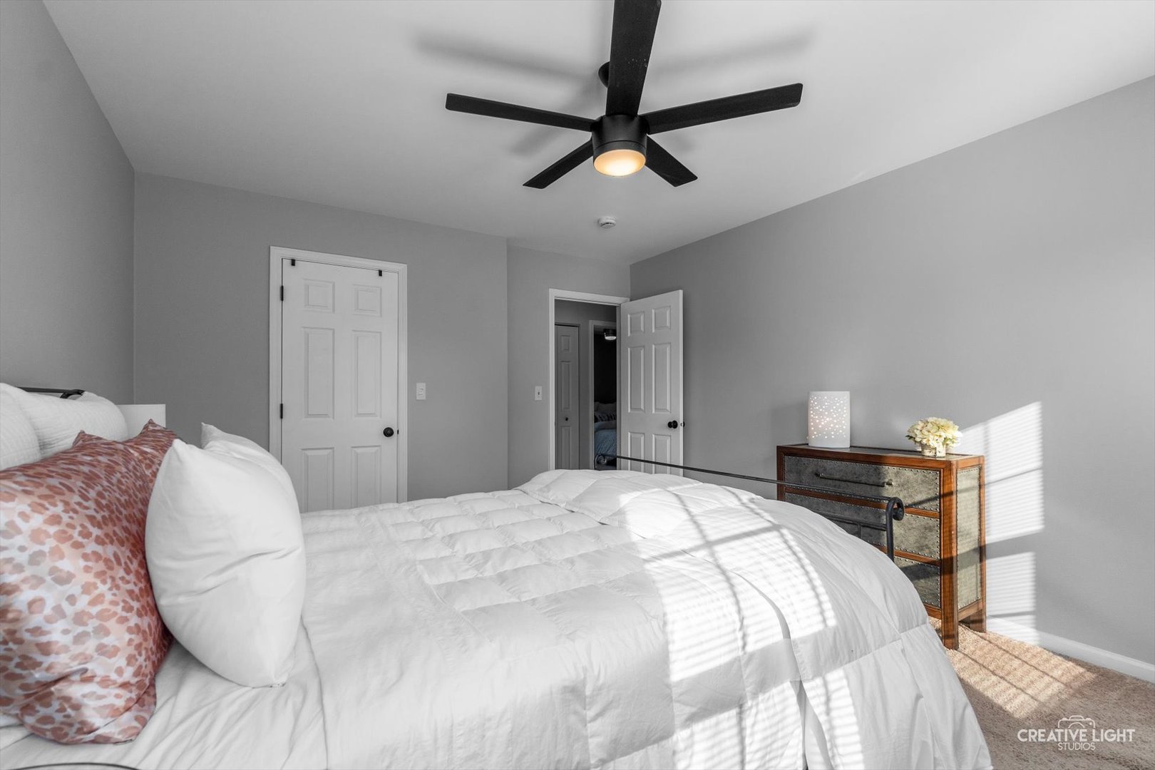 895 Lowell Lane Naperville, IL 60540 - Photo 15 of 40 a bedroom with a bed and a chandelier