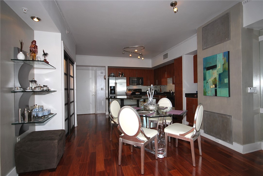 54 Rainey Street, Unit 509 Austin, TX 78701 - Photo 13 of 33 a dining room with furniture and wooden floor