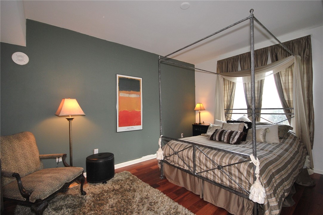 54 Rainey Street, Unit 509 Austin, TX 78701 - Photo 17 of 33 a bedroom with a bed a lamp and a large window