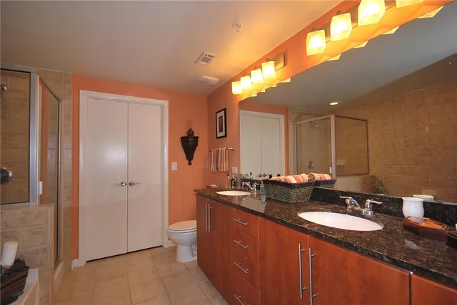 a bathroom with double sink and a mirror