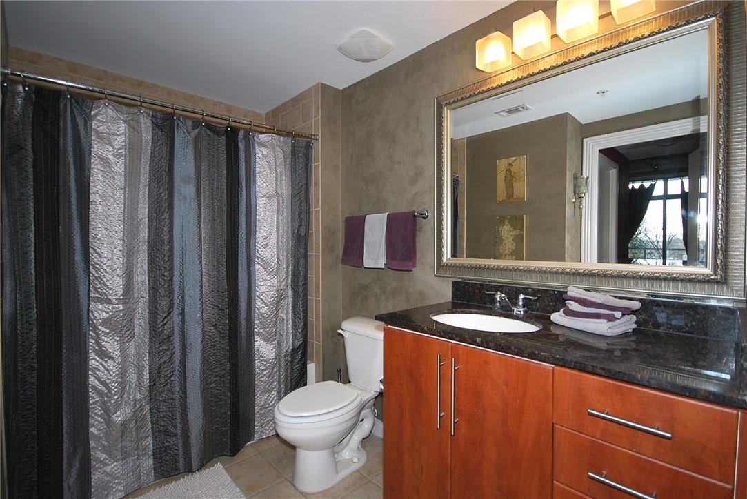 54 Rainey Street, Unit 509 Austin, TX 78701 - Photo 23 of 33 a bathroom with a granite countertop sink and a mirror