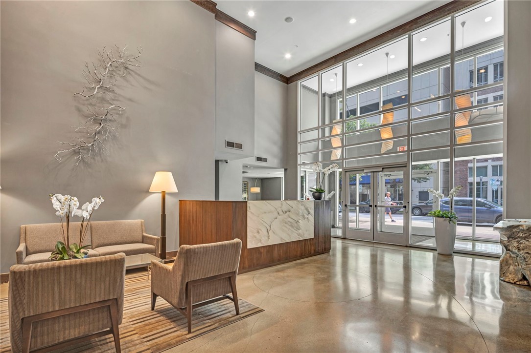54 Rainey Street, Unit 509 Austin, TX 78701 - Photo 24 of 33 a living room with fireplace furniture and a table