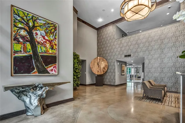 a living room with furniture and a wall painting