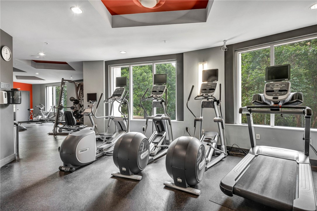 54 Rainey Street, Unit 509 Austin, TX 78701 - Photo 27 of 33 a room with gym equipment and large windows