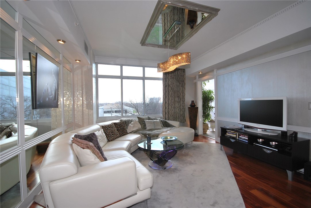 54 Rainey Street, Unit 509 Austin, TX 78701 - Photo 3 of 33 a living room with furniture and a flat screen tv
