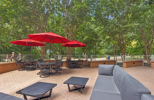 an outdoor space with patio furniture and wooden floor