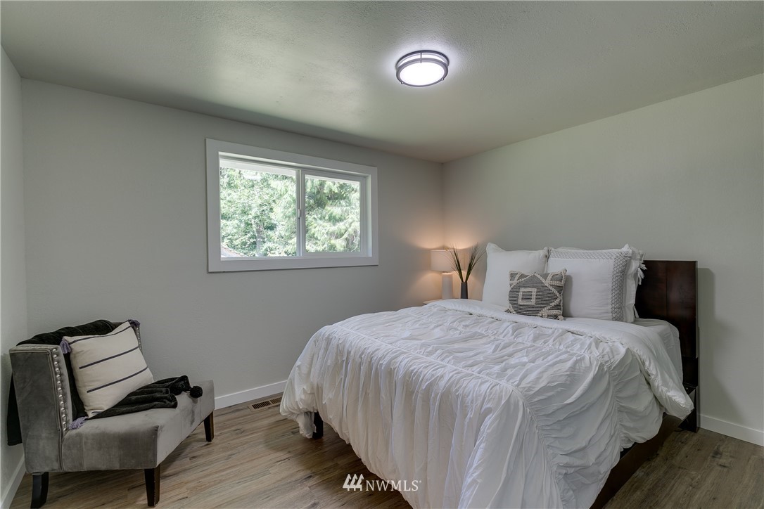 16623 Three Lakes Road Snohomish, WA 98290 - Photo 14 of 36 a bedroom with a bed and a chair