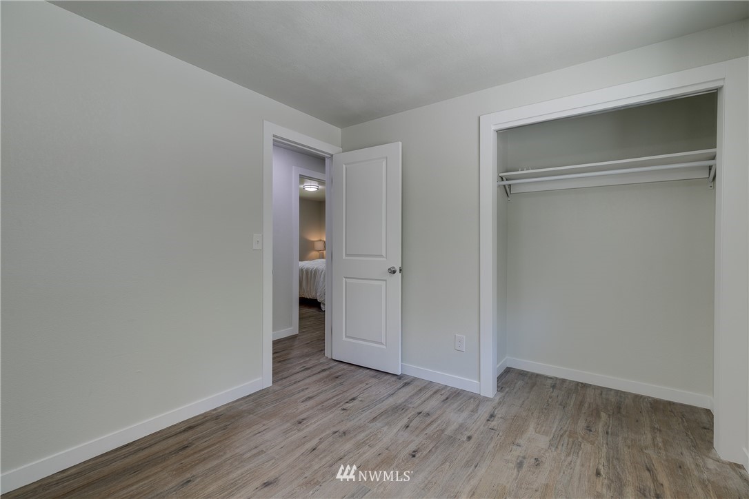 16623 Three Lakes Road Snohomish, WA 98290 - Photo 19 of 36 a view of an empty room with wooden floor and closet