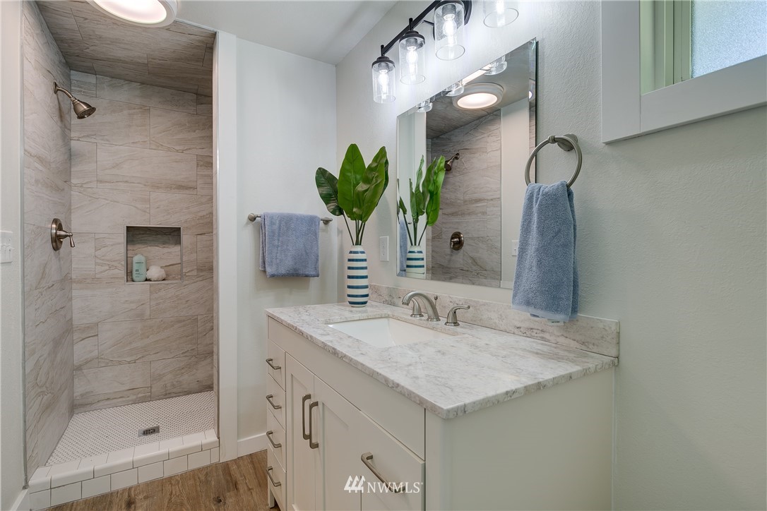 16623 Three Lakes Road Snohomish, WA 98290 - Photo 24 of 36 a bathroom with a granite countertop sink a mirror and a shower